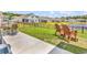Spacious backyard features a patio, green lawn, and a serene pond view at 732 Mustang Ranch Dr., Myrtle Beach, SC 29588