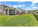 Spacious backyard featuring a screened porch, patio area, and lush green lawn at 732 Mustang Ranch Dr., Myrtle Beach, SC 29588