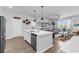Bright kitchen with white cabinets, stainless steel appliances, and an open view of the living room at 732 Mustang Ranch Dr., Myrtle Beach, SC 29588
