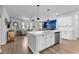 Open-concept kitchen with white cabinets, stainless steel appliances, and a view of the living area at 732 Mustang Ranch Dr., Myrtle Beach, SC 29588