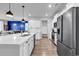 Bright kitchen with an island, stainless appliances, and a view into the living area at 732 Mustang Ranch Dr., Myrtle Beach, SC 29588