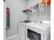 Functional laundry room with modern white washer and dryer and shelving at 732 Mustang Ranch Dr., Myrtle Beach, SC 29588