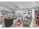 Bright living room with wood floors, a ceiling fan, and plenty of natural light at 732 Mustang Ranch Dr., Myrtle Beach, SC 29588