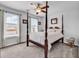 Bright main bedroom featuring a four-poster bed, ceiling fan, and large windows overlooking the neighborhood at 732 Mustang Ranch Dr., Myrtle Beach, SC 29588