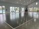 Bright indoor pickleball court with tall ceilings, bright windows, and access to an outdoor pool area at 732 Mustang Ranch Dr., Myrtle Beach, SC 29588
