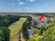 Aerial view of property featuring golf course views, pond, trees, and convenient parking at 901 Knoll Shores Ct. # 304, Murrells Inlet, SC 29576