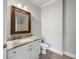 Bathroom with white vanity, framed mirror, and a toilet at 901 Knoll Shores Ct. # 304, Murrells Inlet, SC 29576
