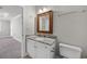 Bathroom features a granite countertop, white cabinets, and wood-framed mirror at 901 Knoll Shores Ct. # 304, Murrells Inlet, SC 29576