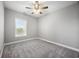 Empty bedroom with neutral carpet, ceiling fan, and a bright window view at 901 Knoll Shores Ct. # 304, Murrells Inlet, SC 29576