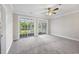 Bright bedroom featuring plush carpet, ceiling fan, and sliding glass doors to an outdoor balcony at 901 Knoll Shores Ct. # 304, Murrells Inlet, SC 29576