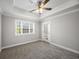 A simple bedroom with a trey ceiling, a window and an exterior door at 901 Knoll Shores Ct. # 304, Murrells Inlet, SC 29576