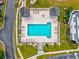 Aerial view of a community pool surrounded by lounge chairs and palm trees, perfect for relaxing at 901 Knoll Shores Ct. # 304, Murrells Inlet, SC 29576