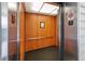 Interior of the building elevator featuring wood paneling and modern design, offering convenient access to floors at 901 Knoll Shores Ct. # 304, Murrells Inlet, SC 29576
