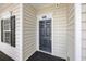 Inviting front entrance featuring a black door, sidelight window and the unit number above the door at 901 Knoll Shores Ct. # 304, Murrells Inlet, SC 29576