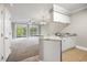 Open concept kitchen with breakfast bar, stainless appliances, and view to the living area at 901 Knoll Shores Ct. # 304, Murrells Inlet, SC 29576