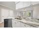 Kitchen counter and cabinets with a view into an adjacent room with a chandelier and exterior view at 901 Knoll Shores Ct. # 304, Murrells Inlet, SC 29576