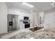 A modern kitchen with white cabinets, stainless steel appliances and light granite countertops at 901 Knoll Shores Ct. # 304, Murrells Inlet, SC 29576