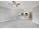 Open concept living room featuring plush carpet, ceiling fan, and a pass through to the kitchen at 901 Knoll Shores Ct. # 304, Murrells Inlet, SC 29576