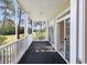 Relaxing screened porch featuring golf course views and sliding glass doors for seamless indoor-outdoor living at 901 Knoll Shores Ct. # 304, Murrells Inlet, SC 29576