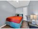 Quaint bedroom with a full bed, bright orange blanket, and ample closet space for storage at 9400 Shore Dr. # 206, Myrtle Beach, SC 29572