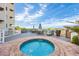 Relaxing hot tub with lounge chairs and tables near the resort building and ocean views at 9400 Shore Dr. # 206, Myrtle Beach, SC 29572