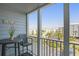 Relaxing condo balcony view featuring a table, chair, and views of the beach and parking at 9581 Shore Dr. # 216, Myrtle Beach, SC 29572