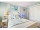 Cozy bedroom with coastal decor, featuring a queen bed, side tables, and ample closet space at 9581 Shore Dr. # 216, Myrtle Beach, SC 29572