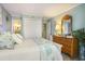 Bedroom with a king size bed, dresser with mirror, and closet doors at 9581 Shore Dr. # 216, Myrtle Beach, SC 29572
