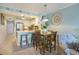 Dining area with a kitchen view featuring coastal accents and a decorative wall clock at 9581 Shore Dr. # 216, Myrtle Beach, SC 29572
