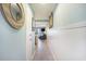 Hallway with pale blue walls and wood-look floors leading to the living area at 9581 Shore Dr. # 216, Myrtle Beach, SC 29572