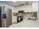 Well-lit kitchen featuring stainless steel appliances, granite countertops, and white cabinetry at 9581 Shore Dr. # 216, Myrtle Beach, SC 29572