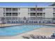 Sparkling community pool with blue lounge chairs and seating, perfect for relaxation at 9581 Shore Dr. # 216, Myrtle Beach, SC 29572