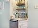 A stylish wet bar features shelving, cabinets, a mini-fridge, and a sink at 9581 Shore Dr. # 216, Myrtle Beach, SC 29572