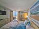 Bright bedroom featuring balcony access with ocean views and beach themed decor at 9650 Shore Dr. # 1203, Myrtle Beach, SC 29572