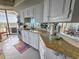 Galley kitchen with granite countertops, mirrored backsplash, modern appliances, and ocean views at 9650 Shore Dr. # 1203, Myrtle Beach, SC 29572