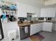 Bright kitchen with white cabinetry, stainless steel dishwasher, and easy access to the balcony at 9650 Shore Dr. # 1203, Myrtle Beach, SC 29572