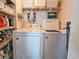 Laundry room with a washer, dryer and storage shelves at 9650 Shore Dr. # 1203, Myrtle Beach, SC 29572