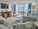 Bright living room with comfortable seating, a stylish entertainment center, and ocean views at 9650 Shore Dr. # 1203, Myrtle Beach, SC 29572