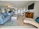 Bright living room with stylish furnishings, a large mirror, and an open layout to the entryway and other rooms at 9650 Shore Dr. # 1203, Myrtle Beach, SC 29572