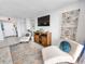Cozy living room featuring comfortable seating, a stylish entertainment center, and a view of the entrance at 9650 Shore Dr. # 1203, Myrtle Beach, SC 29572