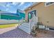 Inviting back porch with white railing, a chair, and charming brick pavers at 99 Berry Tree Dr., Pawleys Island, SC 29585