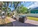 Enjoy outdoor living on this backyard patio with wicker furniture and mature trees at 99 Berry Tree Dr., Pawleys Island, SC 29585