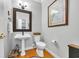 Half bathroom features pedestal sink, toilet and decorative accessories at 99 Berry Tree Dr., Pawleys Island, SC 29585