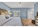 Comfortable bedroom features wood floors, calming light-blue walls, and access to a bathroom at 99 Berry Tree Dr., Pawleys Island, SC 29585