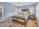 Comfortable bedroom features wood floors, calming light-blue walls, and a large comfortable bed at 99 Berry Tree Dr., Pawleys Island, SC 29585