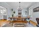 Bright dining room featuring wooden table, bench, and decorative chandelier at 99 Berry Tree Dr., Pawleys Island, SC 29585
