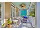 Relaxing front porch with comfortable seating, ceiling fan, and a tranquil outdoor ambiance at 99 Berry Tree Dr., Pawleys Island, SC 29585