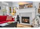 Cozy living room with fireplace, red sofa, and decorative bear accent at 99 Berry Tree Dr., Pawleys Island, SC 29585