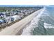 Beautiful aerial view of the coastline features ocean views, residential buildings, and pristine beach access at 1011 S Ocean Blvd., Surfside Beach, SC 29575