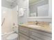Well-lit bathroom features a granite countertop, a shower-tub combo, and ample storage space beneath the sink at 1011 S Ocean Blvd., Surfside Beach, SC 29575